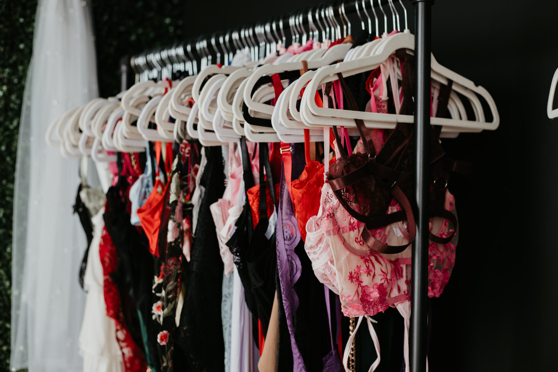 Colorful lingerie on hangers from the Arielle Roth Boudoir client closet in Bay City, Michigan