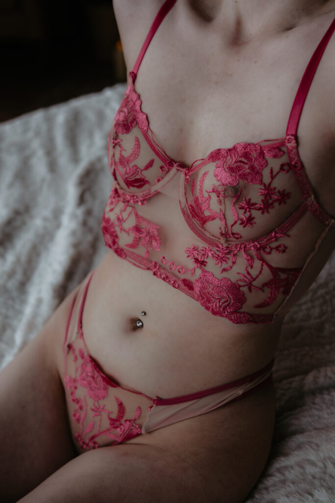 Boudoir photography in Bay City Michigan with close-up of sheer pink floral lingerie