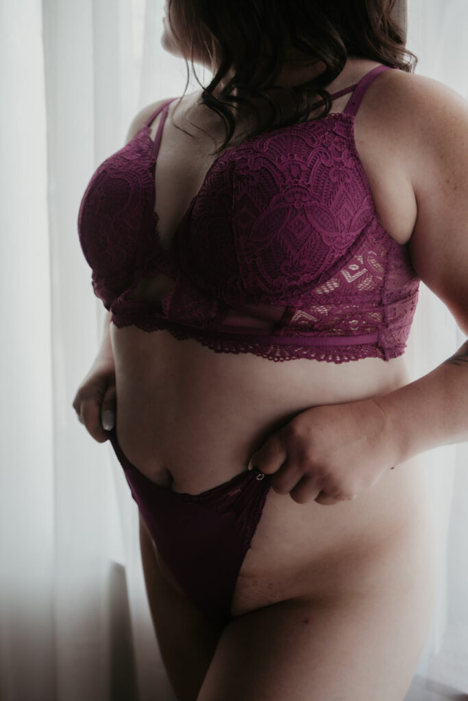Michigan boudoir photography close-up of mature Saginaw client over 40 in purple lace lingerie.