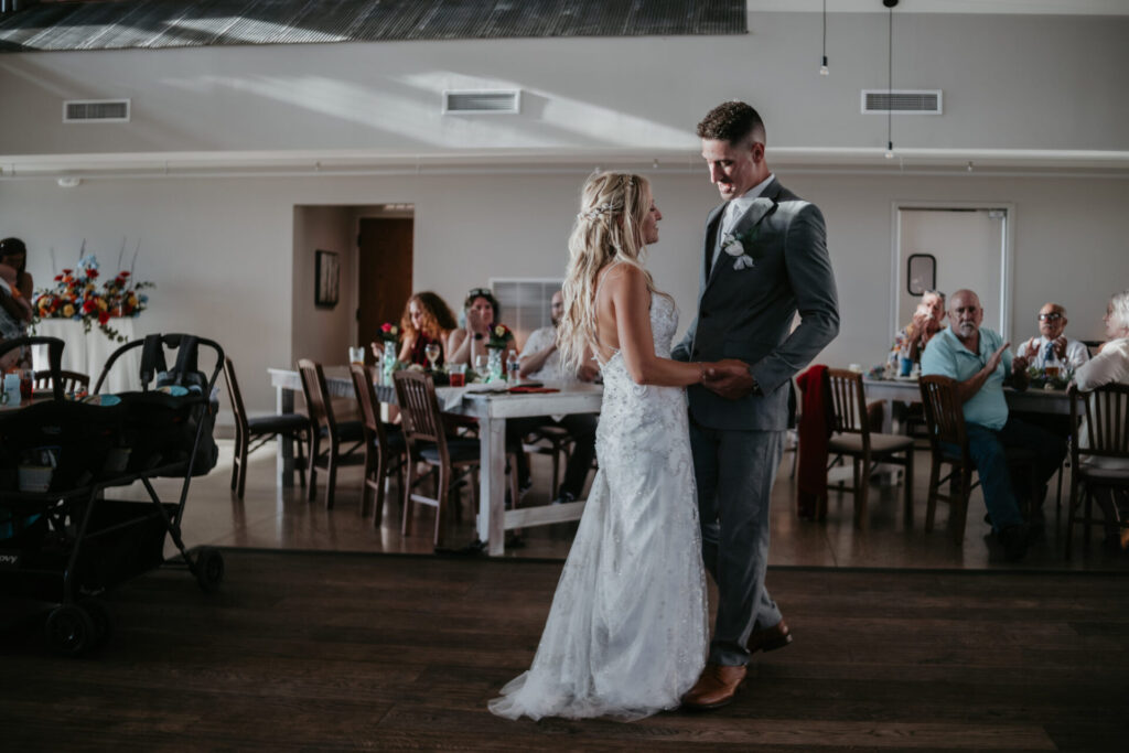 Bride and groom share a romantic first dance at The Lake House Ludington wedding reception.